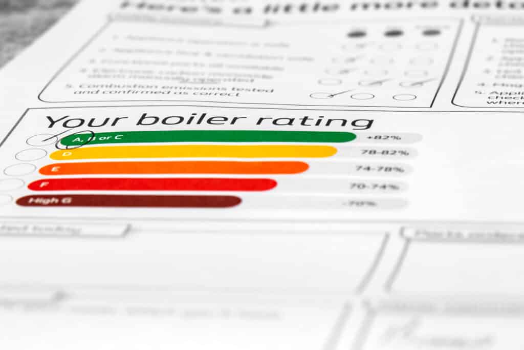 Customer household boiler rating on a service inspection document. Cost of living energy efficiency concept.